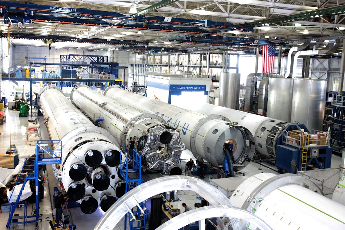 Free View of a spacecraft assembly line with rockets in a spacious hangar. Stock Photo